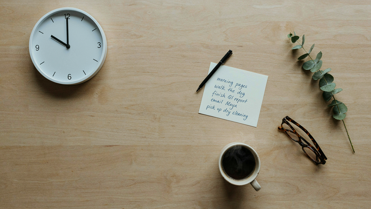 Time Management Mistakes: Solutions for Better Productivity 1 Overhead view of an organized desk with a clock, to-do list, and planner for effective time management